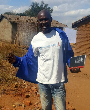 Mr Black talking to villagers